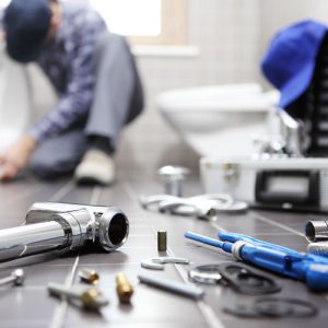 Plumbers Fixing Bathroom Plumbing